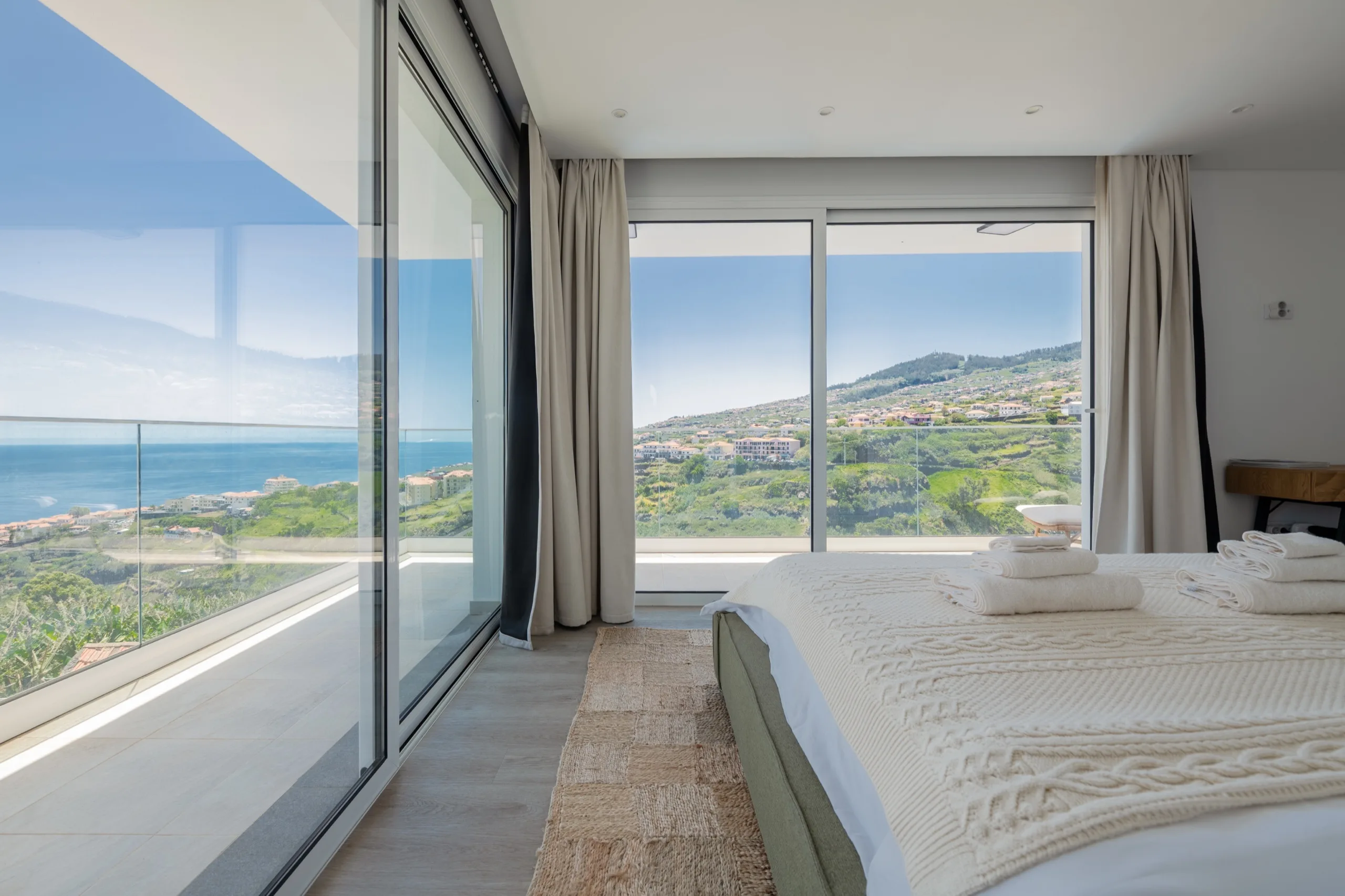 A Villa Calma bedroom with a panoramic view over the Madeira coast